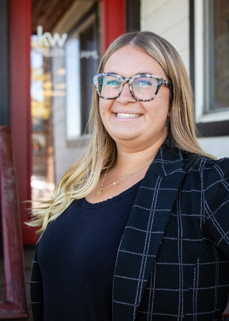 A woman with glasses and a jacket on.